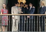 (L-R) Mexico President Claudia Sheinbaum stands with BTS members V, RM, Jung Kook, Suga and Jimin as they greet fans from the balcony of the National Palace at Zócalo Square in Mexico City, May 6, 2026. BTS held three sold-out shows at Estadio GNP Seguros.
