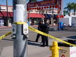 Police officers stand guard near the scene of a deadly shooting on Sunday in Monterey Park, Calif. 10 people were killed and 10 more were injured at a dance studio near a Lunar New Year celebration on Saturday night.
