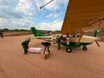 Virunga rangers unload basic immediate supplies for the health services, including body bags and diagnostic kits.