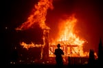 FILE - In this Nov. 8, 2018, file photo, a home burns as a wildfire called the Camp Fire rages through Paradise, Calif. In an order dated July 12, 2021, Los Angeles County Superior Court Judge Mary Strobel ruled that California Insurance Commissioner Richard Lara has the power to order the state's "Insurer of last resort" to offer more options for homeowners who can't buy traditional coverage because they live in areas threatened by wildfires.