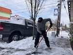 Greg Palin shovels the sidewalk in front of his wife’s business, a yarn shop called Close Knit on Northeast Alberta Street, in Portland on Thursday, Feb. 23, 2023. A snow storm covered the metro area in several inches of snow, making roads icy and leading to several school and business closures.