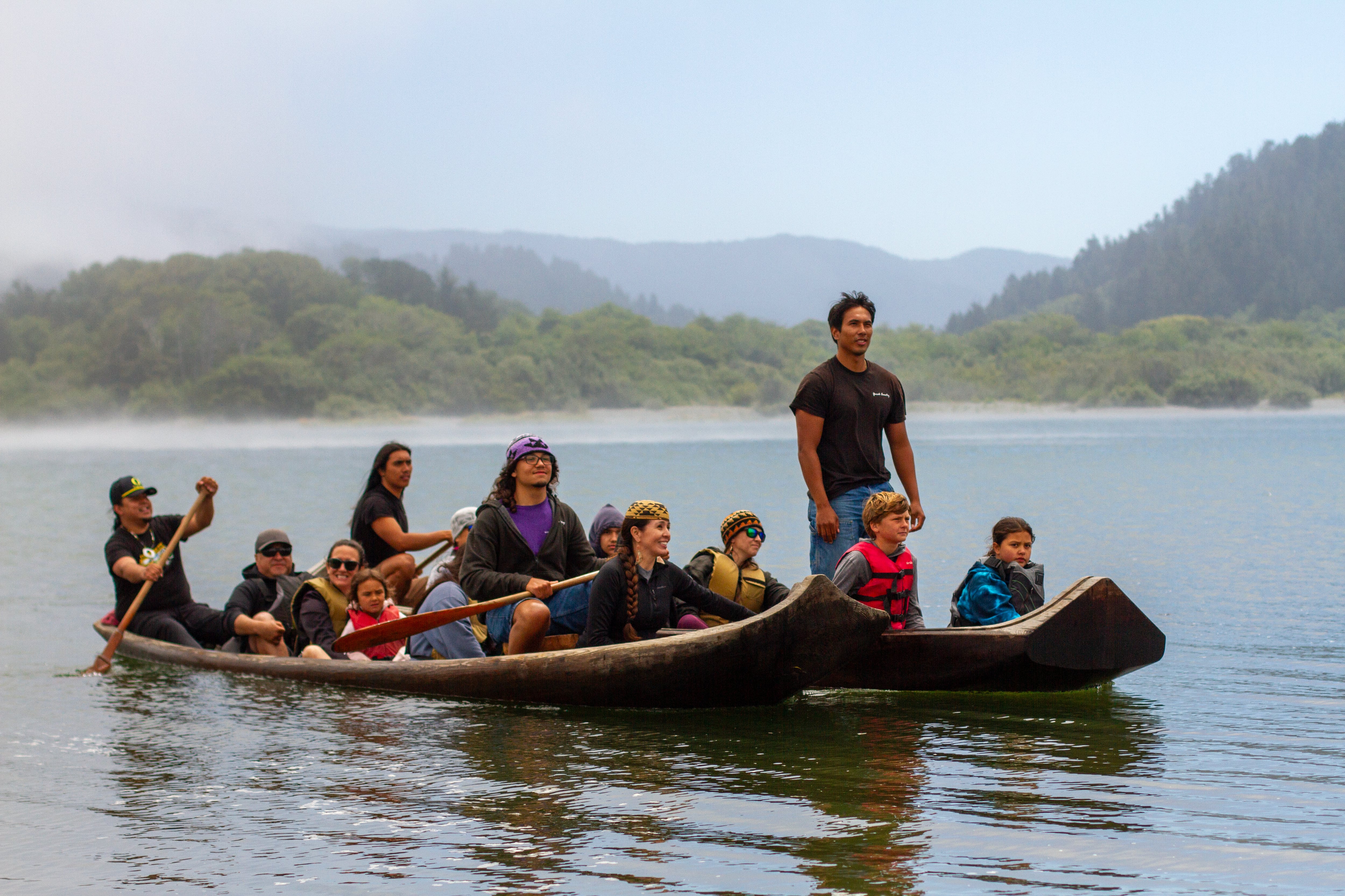 Two traditional Redwood dugout canoes joined the group and led the kayakers to the final landing on July 11, 2025.