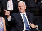Vice Presidential nominee Gov. Mike Pence of Indiana points as he sits during the second day session of the Republican National Convention in Cleveland, Tuesday, July 19, 2016.