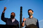 Georgia Democratic candidates for U.S. Senate Raphael Warnock, left, and Jon Ossoff, right, gesture toward a crowd during a campaign rally on Sunday, Nov. 15, 2020, in Marietta, Ga.