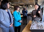 PCC Quick Start student Sofya Chen (right) shows off a project she worked on to Oregon Congresswoman Suzanne Bonamici (center-left) and Acting U.S. Labor Secretary Julie Su (left).