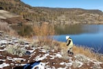 Yurok tribal member and Fish Technician 1 Frank Henry Jr. works alongside Iron Gate Reservoir in Feb. 2023. The reservoir will be drained when Iron Gate Dam is removed as part of the Klamath River restoration.