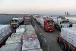 Trucks carrying aid wait on the Egypt side of border at the closed Rafah crossing to the Gaza Strip on Monday.