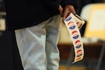 A poll worker holds "I Voted" stickers as people cast ballots on Nov. 4 in  the Brooklyn borough of New York City.