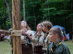 The younatstvo, campers ages 12-18, attend to the daily flag-raising ceremony on the hand-crafted flag pole.