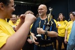 Andy Chappell, an inmate at Oregon State Penitentiary in Salem, Ore., holds his team's trophy after winning the debate.