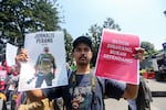 A journalist holds posters during a demonstration for International Labor Day at Cikapayang Park in Bandung, West Java, Indonesia, on May 1.