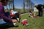 (from left) Alex Olivas guides Callum in play while Waukeen learns how to use a spray bottle with teacher Miriam Romero at The Children's Learning Center at Central Oregon Community College in Madras, Ore., on June 4, 2026.