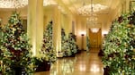 Trees line the Grand Foyer inside the White House.