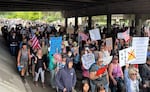Attendees march along Southwest Naito Parkway, passing underneath the Hawthorne Bridge, during the “No Kings” rally in Portland, Ore., June 14, 2025.