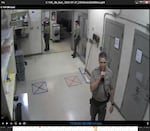 Sgt. Matt Savage puts his finger to his lips in a shushing gesture after deputy Jeanamarie Fisher re-enacted the altercation with Anton Williams.