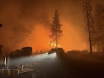 Crews provide structural protection for private residences in the path of the Akawa Butte Fire near Sisters, Ore., July 21, 2026.