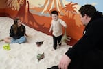 Tyson Morris watches as his children, Grace Hagerty, left, and Milo Morris play at an indoor playground DiG PDX in Portland, Ore. on Thursday, Nov. 6, 2025.