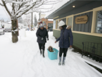 Khalleeah Sparks (right) pulls her god daughter, Mylai, in a makeshift sled with Glynnis Woods on their way to the grocery store.