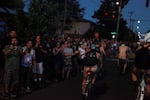 Spectators line up on the streets adjacent to Southeast 74th and Southeast Knight Street cheering on and taking photos of nude riders.