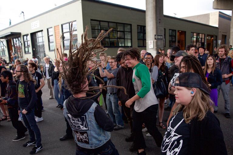 A man's dreadlocks fly through the air while head banging to the hard-hitting, heavy sounds of Saola. As one of, if not, the youngest bands on the lineup, Saola surprises audiences by playing doom metal influenced by The Melvins in contrast with their youthful demeanor.