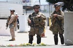Members of the California National Guard and U.S. Marines guard a federal building on Tuesday, June 17, 2025, in Los Angeles.