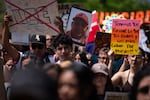 A marcher holds a sign with the face of Luis Beltrán Yanez-Cruz, who died in U.S. Immigration and Customs Enforcement custody in California earlier this year. Hundreds marched around the Oregon State Capitol in the Day Without an Immigrant demonstration in Salem, Ore., on May 1, 2026, International Workers’ Day. 