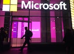 People walk past a Microsoft office in New York in 2016. Big Tech companies, like Google and Microsoft, and dozens of smaller startups have collectively shed more than 20,000 workers so far this year.
