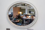 FILE - Reflected in a mirror on the wall, students work in a sixth grade class on the first day of school at Parkrose Middle School in Portland, Ore., in August.