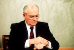 Soviet President Mikhail Gorbachev checks the time on his watch before his resignation speech in the Kremlin on Wednesday, Dec. 25, 1991.