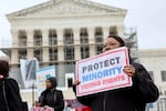 A demonstrator holds a sign saying “PROTECT MINORITY VOTING RIGHTS” at a March 2025 rally outside the U.S. Supreme Court in Washington, D.C.