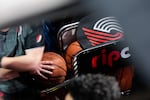 A member of the Trail Blazers promotion team prepares to wheel out a cart of basketballs during a National Basketball Association game between the Portland Trail Blazers and the Toronto Raptors at the Moda Center in Portland, Ore., Wednesday, Nov. 13, 2019. The Raptors won 114-106.