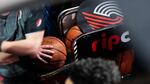 A member of the Trail Blazers promotion team prepares to wheel out a cart of basketballs during a National Basketball Association game between the Portland Trail Blazers and the Toronto Raptors at the Moda Center in Portland, Ore., Wednesday, Nov. 13, 2019. The Raptors won 114-106.