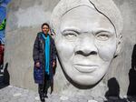 Architect Nina Cooke John stands with the Harriet Tubman monument she designed titled "Shadow of a Face," in Newark, N.J., Thursday, March 9, 2023.