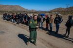 On this day, U.S. Border Patrol tells families with children to line up. They are soon taken away in a van.