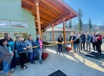 As caregivers and McKenzie Valley Wellness board members look on, East Lane County Commissioner Heather Buch cuts a ribbon to the entrance of the new McKenzie River Clinic in Blue River on Oct. 25, 2024.