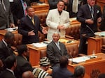 South African President Nelson Mandela smiles as he receives a standing ovation after making his final address to Parliament on March 26, 1999.