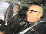 Will Lewis (left) rides with controlling News Corp. owner Rupert Murdoch as they leave the headquarters of his company's British publishing arm in July 2011. Murdoch tasked Lewis with helping to clean up a massive hacking scandal.