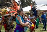 Dayanara Velasquez (center) dances with son, Tonatiuh, at the 24th annual salmon bake in Bend, Ore. on May 18, 2024. Velasquez is a member of the MexicaTiahui Aztec dance group from Portland.