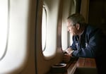 President George W. Bush looks out the window of Air Force One on August 31, 2005, as he surveys Hurricane Katrina damage over New Orleans on his way from Texas to Washington, D.C. 