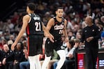 Portland Trail Blazers forward Kris Murray, right, celebrates the made basket with Rayan Rupert, left, during the first half of an NBA basketball game Sunday, April 13, 2025, in Portland, Ore.