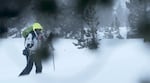 Carla Danley skis through the snow, en route to a backcountry hut.