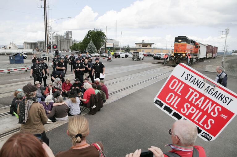 Police move on a group of protesters blocking the tracks at the BNSF Railway station in Vancouver, Washington, on Saturday, June 18, 2016.