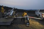 Ty Sibley, right, an unmanned aircraft system operator for Insitu, prepares a ScanEagle drone on a ridge south of Galesville Reservoir near Azalea, Ore. on Aug. 7, 2018.