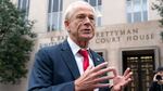 Former Trump White House official Peter Navarro talks to the media as he arrives at U.S. Federal Courthouse in Washington on Thursday.