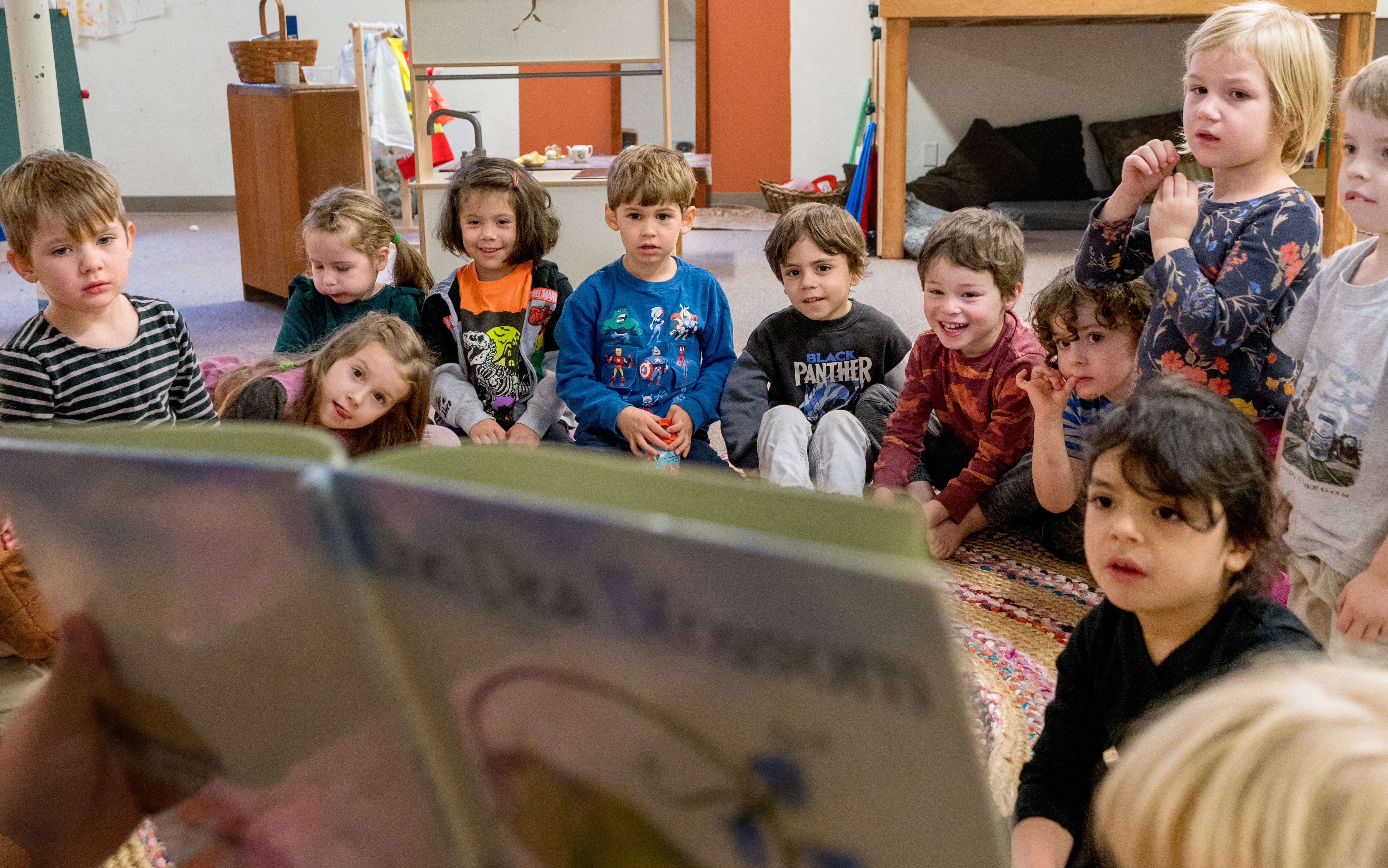 Students listen during reading time at Escuela Viva Community School’s Southeast location, Oct. 26, 2023. The bilingual child care program is part of Multnomah County’s Preschool for All.