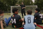 Coach Omar Abdulaziz leads a practice with the Palestino Soccer Academy. He says the sport gives kids a moment to detach from the realities of suffering and conflict.