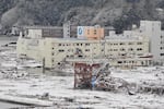 The disaster prevention center established by the Japanese town of Minamisanriku, red at center, was inundated by water when a tsunami swept the community March 11, 2011.