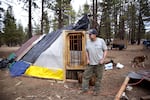 Steven Putnam stands next to the bath house he recently finished for his girlfriend, Penny in the Deschutes National Forest on Mar. 24, 2025