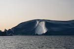 The sunset reflects off of an iceberg in Ilulissat.