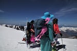 Friends of Kathy Phibbs look into the crater of Mount St. Helens during a climb in her memory.